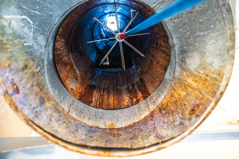 Brush cleaning the inside of a trash chute