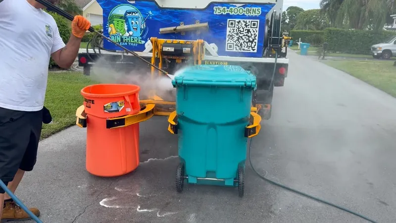 Crew washing two trash bins