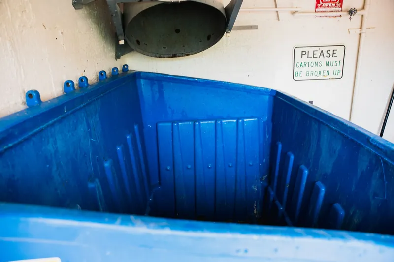 The same dumpster after cleaning, bright blue interior