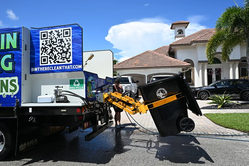 Bin There Clean That truck lift tipping a trash can into the wash bay